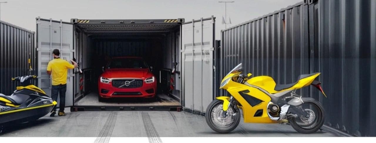 A car, a motorcycle and a jet ski next to a shipping container